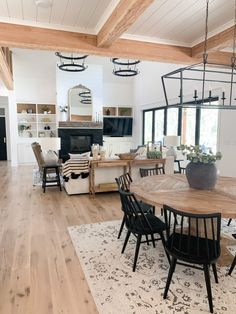 an open concept kitchen and dining room with wood flooring, white walls and ceiling