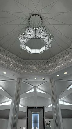 the ceiling in this building is made of glass and metal, with geometric designs on it