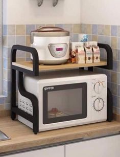 a microwave oven sitting on top of a counter next to a toaster and coffee pot