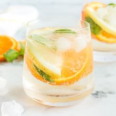 two glasses filled with ice and orange slices