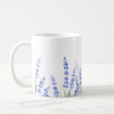 a white coffee mug with blue flowers on it