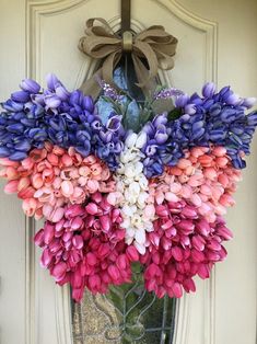 a bunch of flowers that are hanging on a door