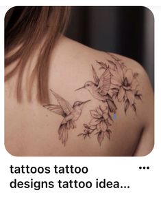 the back of a woman's shoulder with hummingbirds and flowers tattoo on it