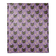 a purple bandanna with black cats and crescents on it