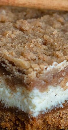 a piece of cake sitting on top of a white and brown plate next to a fork