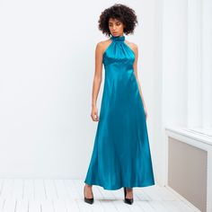 Make a statement with our silk dress in a striking teal hue. Featuring a high-collared neckline, mid-length skirt and a beautiful fit creating a beautiful silhouette. Perfect for weddings, cocktails and holiday occasions. Complement with sandals and a bold earring for an elegant look. This look is the quintessential ready-to-wear item in any coveted wardrobe. Composition: 100% SilkCare: Dry clean only Elegant Silk Halter Cocktail Dress, Silk High Neck Midi Dress For Evening, Chic High Neck Silk Midi Dress, Turquoise Silk Dress For Spring, Luxury Green Silk Evening Dress, Elegant Green Halter Dress For Evening, Luxury Blue Silk Dress, Elegant Green Halter Evening Dress, Elegant Sleeveless Midi Dress In Turquoise