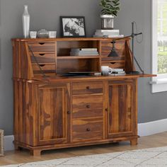 a large wooden cabinet with drawers and shelves