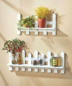 two white shelves with plants and jars on them