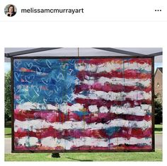 an american flag is on display in front of a building