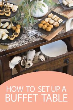 the buffet table is set up with plates and utensils