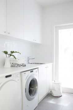 a washer and dryer in a white kitchen