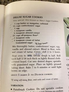 an open recipe book with pictures of cookies