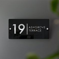 a black and white sign that reads 19 ash grove terrace on the side of a wall