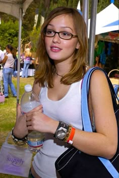 a woman holding a water bottle in her right hand