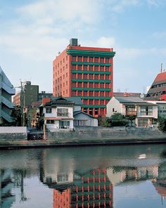 a body of water with buildings in the background