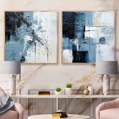 two paintings hang on the wall above a coffee table in a living room with pink chairs