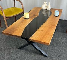 a wooden table with two chairs next to it and a vase on the table top