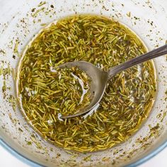 a bowl full of green tea with a spoon in it and some other things inside the bowl