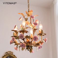 a chandelier with pink flowers hanging from it