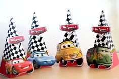 the cars are lined up in front of each other with hats on top of them