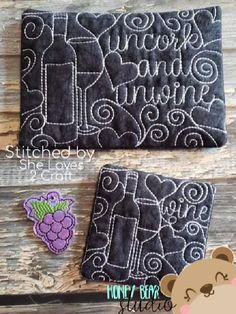 two black and white handmade coasters with embroidered designs on them, one has a teddy bear sitting next to it