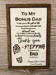 a framed sign that says to my bonus dad