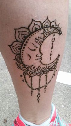 a woman's leg with a tattoo on the side of her body and an image of a crescent moon