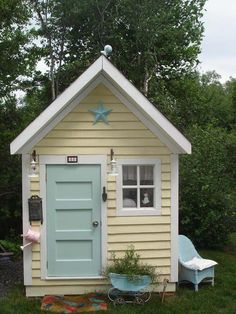 a small yellow house with a blue door