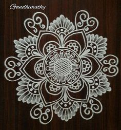 an intricately designed design on the side of a wooden door with white paint and swirls