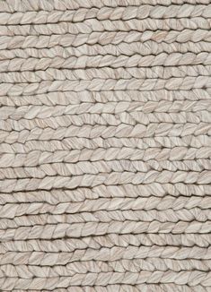 a close up view of the texture of a roped area with white yarn on it