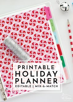 the printable holiday planner is displayed on a desk with markers, pencils and paper