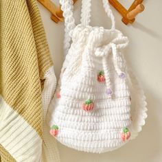 a white crocheted bag hanging from a hook