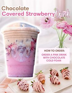 a pink drink with strawberries and ice cream on the table next to it is an advertisement for starbucks's covered strawberry drink