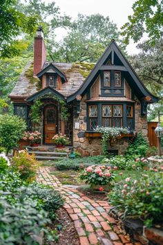 a house that is surrounded by flowers and greenery