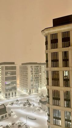 the city is covered in snow at night