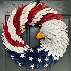 a patriotic wreath with an eagle and stars on the front door, painted red white and blue