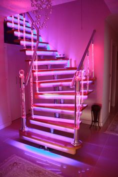 a stair case with pink lights on it