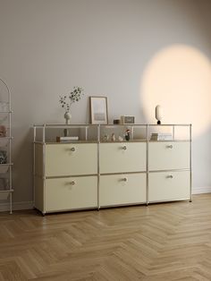 a white dresser sitting on top of a hard wood floor