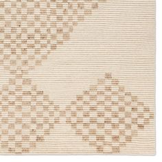 a beige rug with squares on it