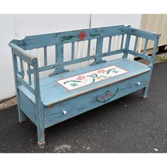 an old wooden bench painted blue with flowers