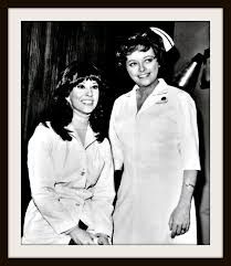 black and white photograph of two women in sailor's uniforms posing for the camera