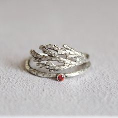 Gemstone leaf ring , Red cz ring , Sterling Silver leaf ring, Juniper leaf ring , Delicate silver ring, Gift for her Delicate sterling silver juniper leaf ring with a 2mm red cubic zirconia stone. This woodland inspired ring has semi oxidized just to help the texture stand out and has matte finish! You will love the details of juniper twig ring and it is adjustable so it can fit in any finger,but please send me your ring size for the best result! *Please note that every piece you purchase from c Silver Leaf Ring As Gift, Silver Leaf-shaped Ring As Gift, Silver Leaf Ring Gift, Delicate Silver Rings, Sugar Skull Ring, Simple Skull, Leaf Skeleton, Succulent Jewelry, Red Gemstone Ring