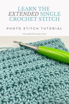 the crochet stitch is being worked on with a green knitting needle in front of it