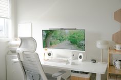 a computer monitor sitting on top of a white desk