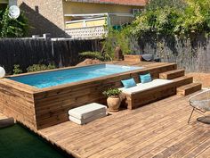 a wooden deck with an above ground pool