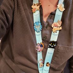 "38in long double-sided Lanyards featuring my original art. This Lanyard is inspired by the popular \"ITA\" Bags that are used to showcase your favorite fandom flair - specifically Enamel Pins! This Lanyard has 8 \"prompts\" in the design to help theme your Pin choices; First, Newest, Favorite, Fandom, Special, Mood, Cutest and Smallest. Gashapon Ball Capsule sketches highlight where you'll place your pin for a fun look. Both Lanyards are completely identical in design with 1 key difference; the Lanyard With Pins, Lanyard Pins, Ita Bags, Badge Holders Lanyard, Lanyard, Double Sided, Original Art, Enamel Pins, Key