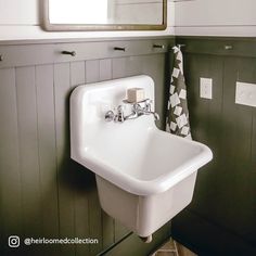 a white sink sitting under a bathroom mirror