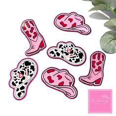 pink and black leopard print stickers on a white background next to a potted plant