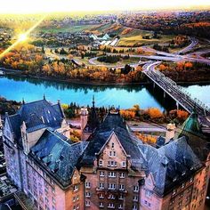 an aerial view of a large building next to a river