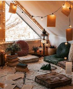 a room with lots of pillows and lights on the ceiling is shown in this instagramted photo